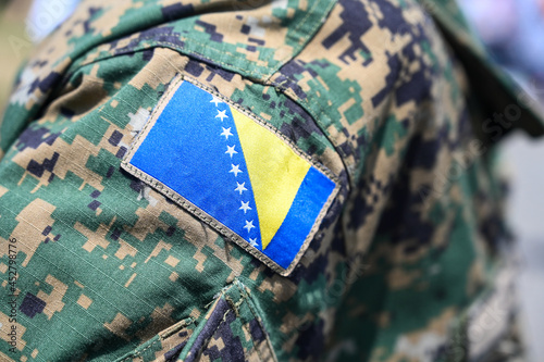 Flag on camouflage uniform. Armed Forces of Bosnia and Herzegovina during official ceremony. Coat of Arms on soldiers shoulder.
