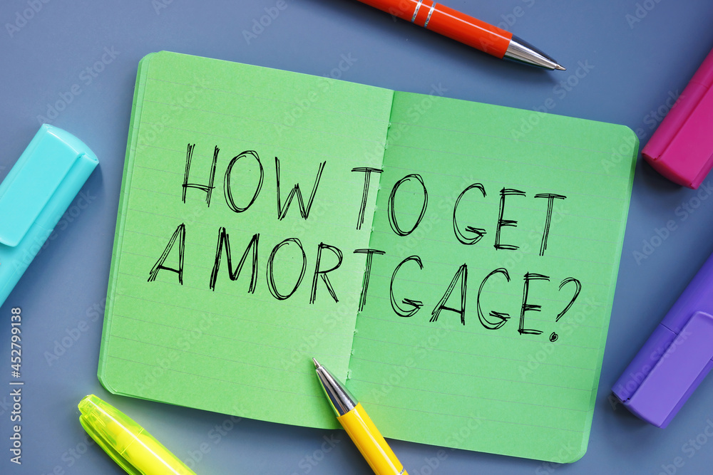 Financial concept meaning HOW TO GET A Mortgage? with inscription on the piece of paper. Financial concept meaning HOW TO GET A Mortgage? with inscription on the piece of paper.
