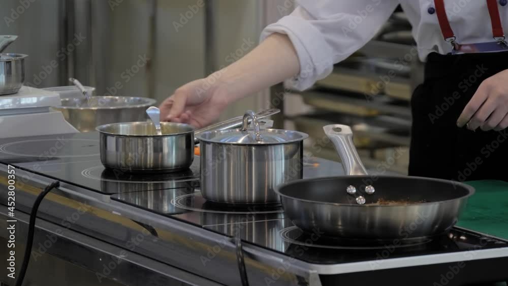 Chef melting butter in pot at cuisine of restaurant. Professional cooking, cookery, gastronomy and healthy food concept Chef melting butter in pot at cuisine of restaurant. Professional cooking, cookery, gastronomy and healthy food concept