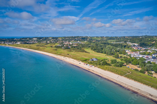 Aerial drone image of Grouville Bay with calm sea, golf course and landscape. Jersey CI © Gary P le Feuvre