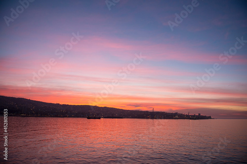 Sunset in Valpraiso city with harbor view and hills by Pacific Ocean, Chile.