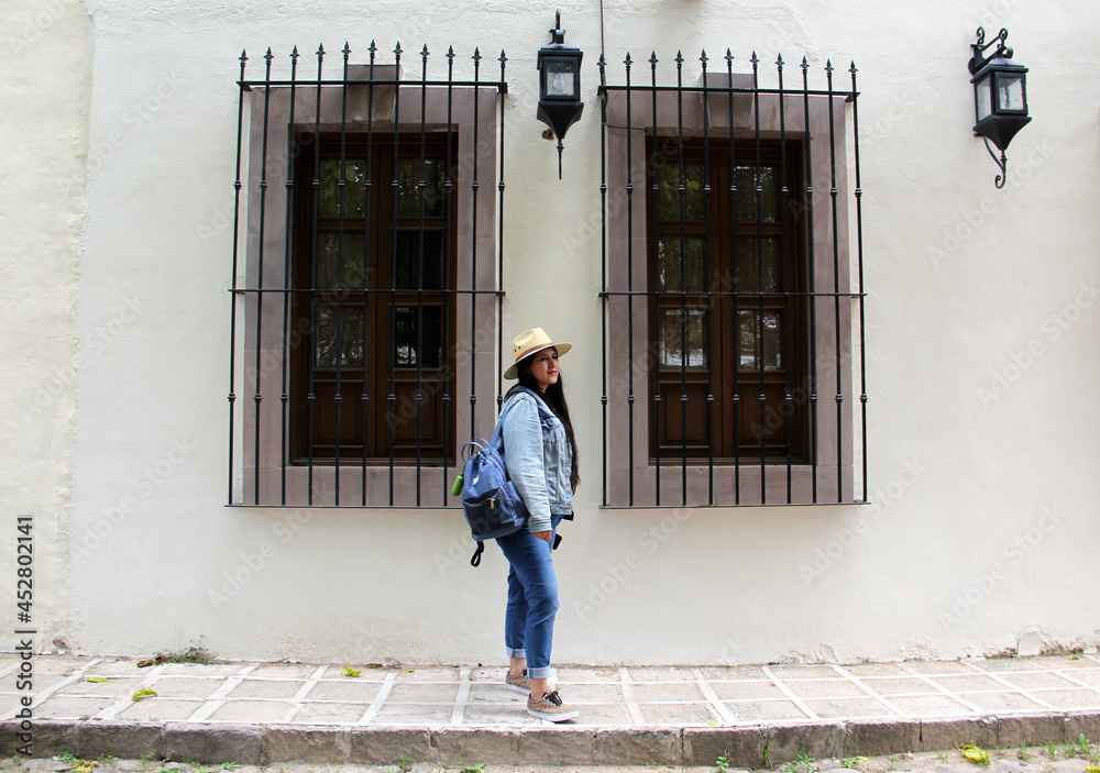 Latin adult female tourist with face mask walking the cobbled streets discovering and exploring a colonial style magical town on vacation in the new normal
Latin adult female tourist with face mask walking the cobbled streets discovering and exploring a colonial style magical town on vacation in the new normal