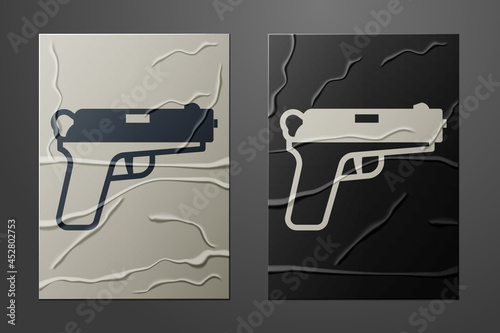 White Pistol or gun icon isolated on crumpled paper background. Police or military handgun. Small firearm. Paper art style. Vector