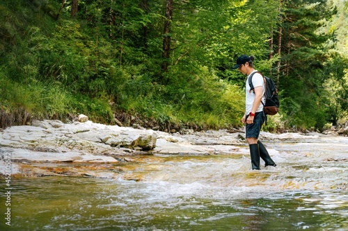 person hiking and walking in the river