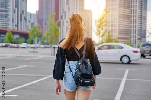 Back view of walking fashionable teenage girl with backpack © Valerii Honcharuk