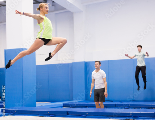 Portrait of positive athletic girl during training in trampoline center. Sport lifestyle concept..