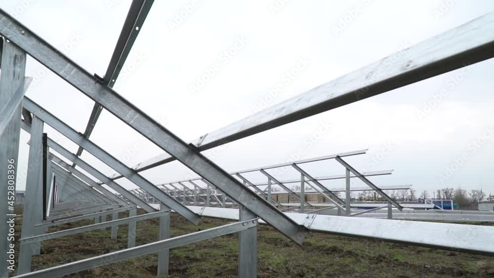 Solar power station construction site, rows of steel racks for solar panels Solar power station construction site, rows of steel racks for solar panels