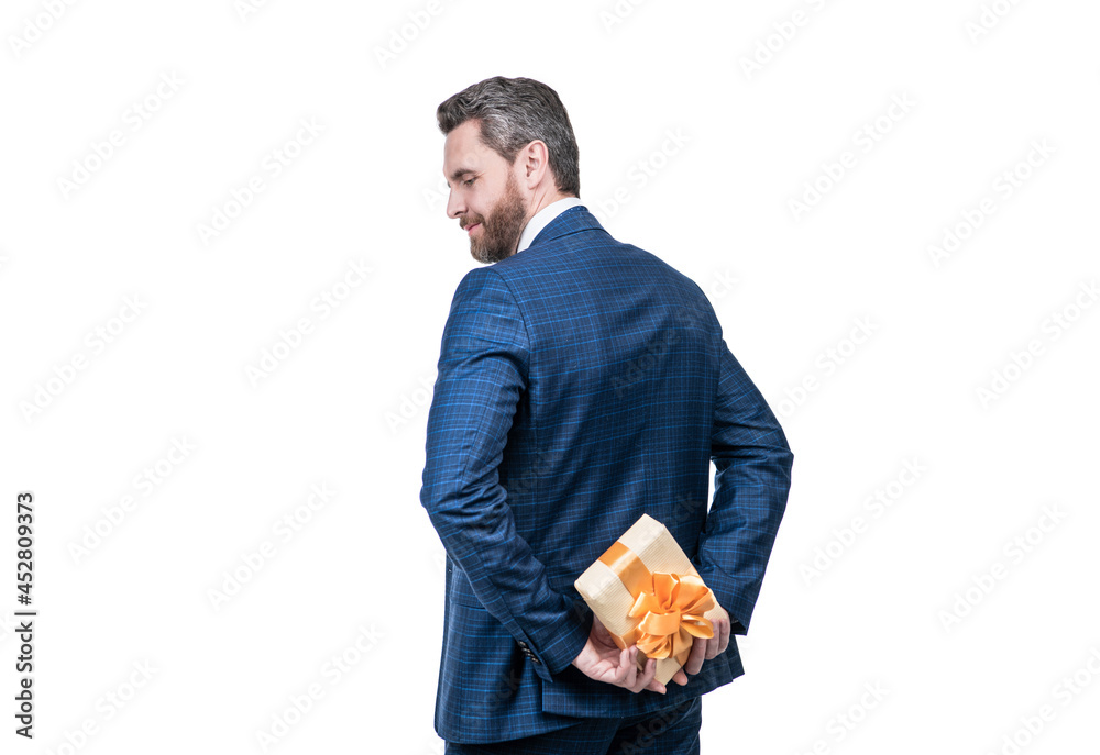 businessman man in businesslike suit hiding present box isolated on white, back view, romance date. businessman man in businesslike suit hiding present box isolated on white, back view, romance date.