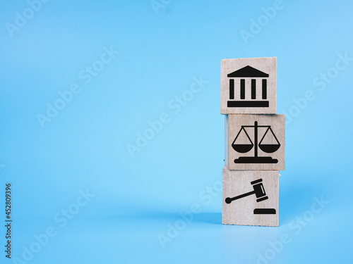 Justice icon on a wooden cube over blue background