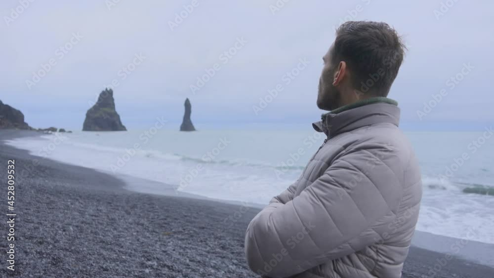 Male Traveler Appreciating the View of the Reynisdrangar Tranquil Ocean Male Traveler Appreciating the View of the Reynisdrangar Tranquil Ocean