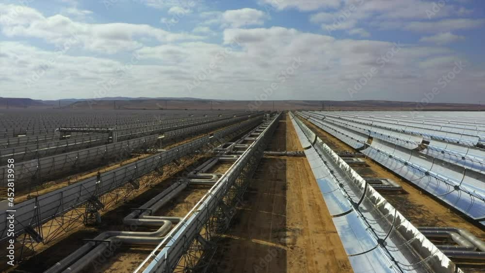 Aerial Shot Of Solar Panels Arranged On Landscape Against Cloudy Sky, Drone Flying Backward During Sunny Day - Negev, Israel Aerial Shot Of Solar Panels Arranged On Landscape Against Cloudy Sky, Drone Flying Backward During Sunny Day - Negev, Israel