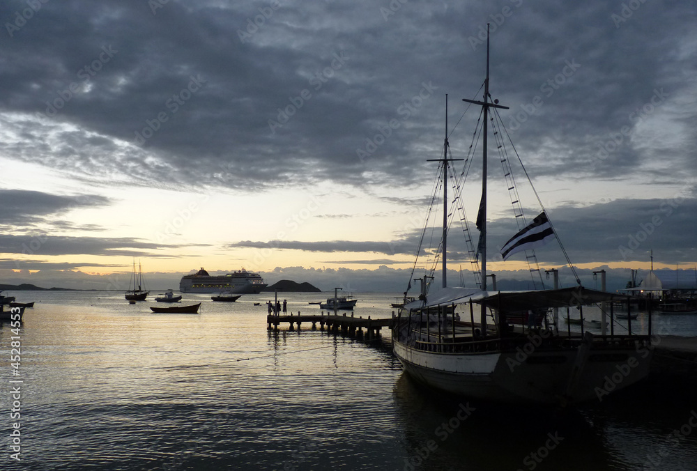 Boats, sailboats and a cruise ship in Armação beach in Buzios, Rio de Janeiro, during the sunset