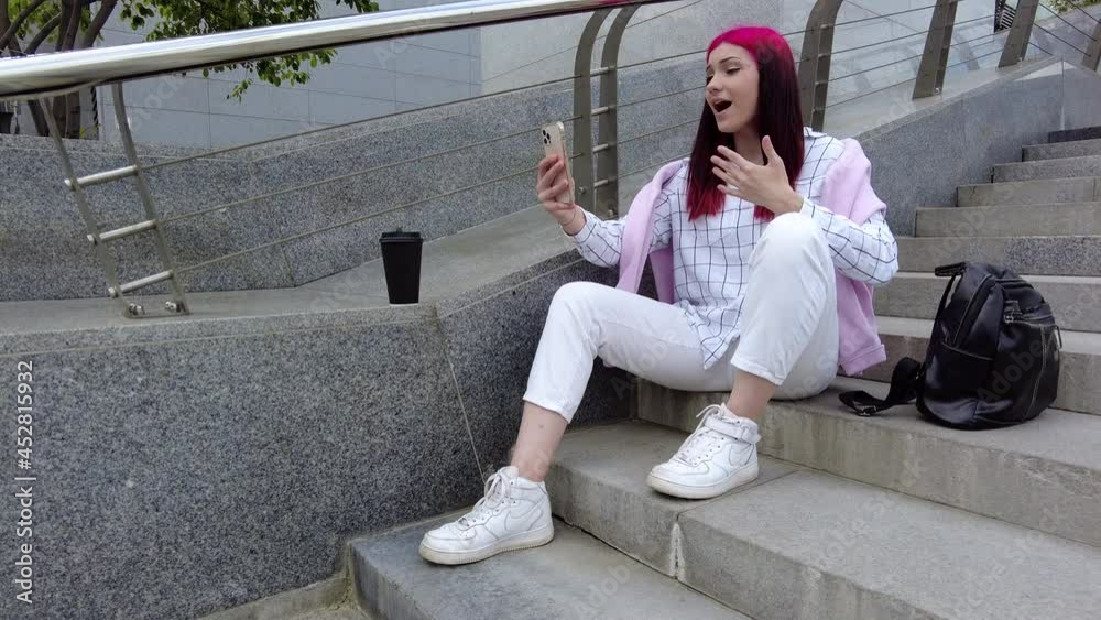 Happy beautiful red haired influencer blogger girl talking making video call using smartphone with her subscribers in social networks. High quality 4k footage Happy beautiful red haired influencer blogger girl talking making video call using smartphone with her subscribers in social networks. High quality 4k footage