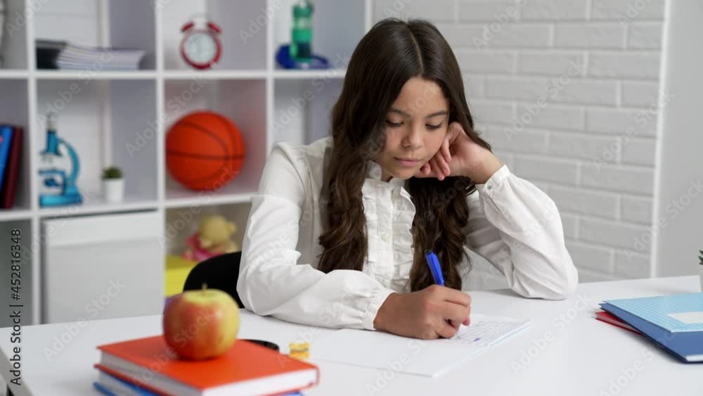 concentrated teen girl in school uniform studying in writing, concentration concentrated teen girl in school uniform studying in writing, concentration