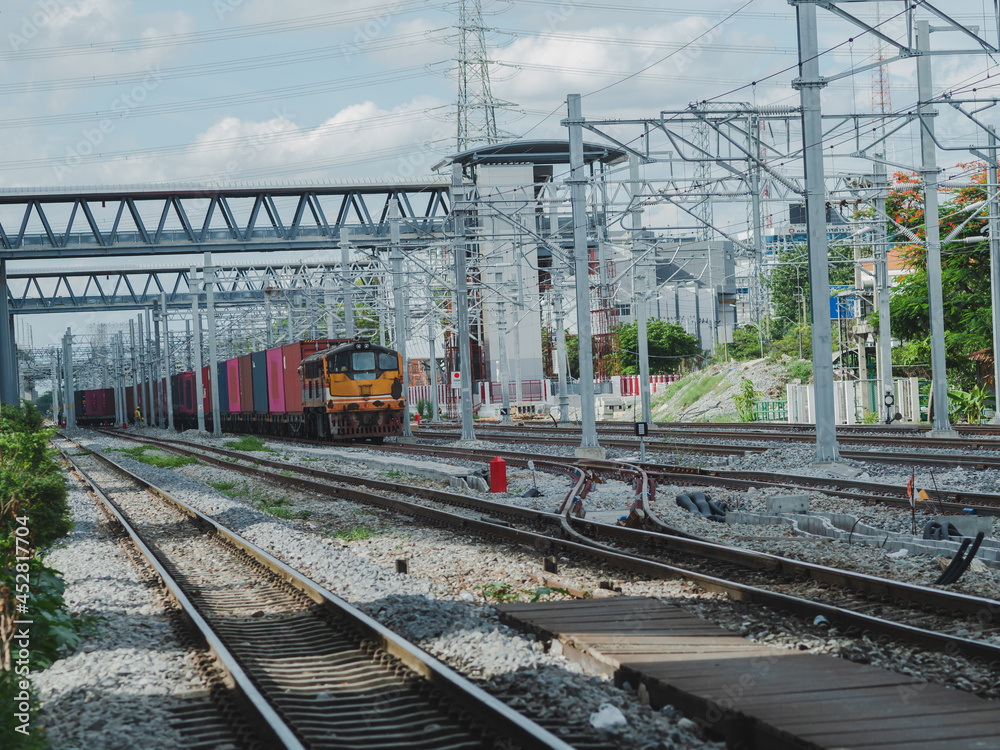 Freight Train with Cargo Containers at Bangkok Railway Station  is the main railway station in Bangkok and Railway station to across the country. background is building downtown.	
