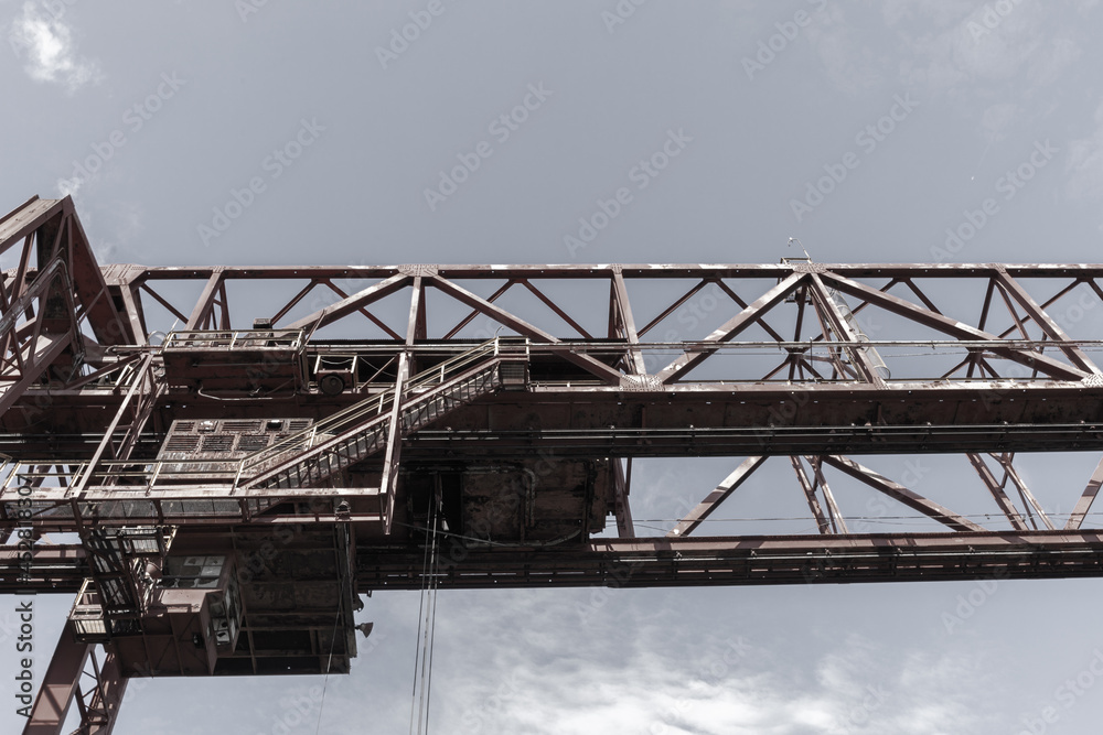 Industrial architecture overhead structure against a grey sky, horizontal aspect Industrial architecture overhead structure against a grey sky, horizontal aspect