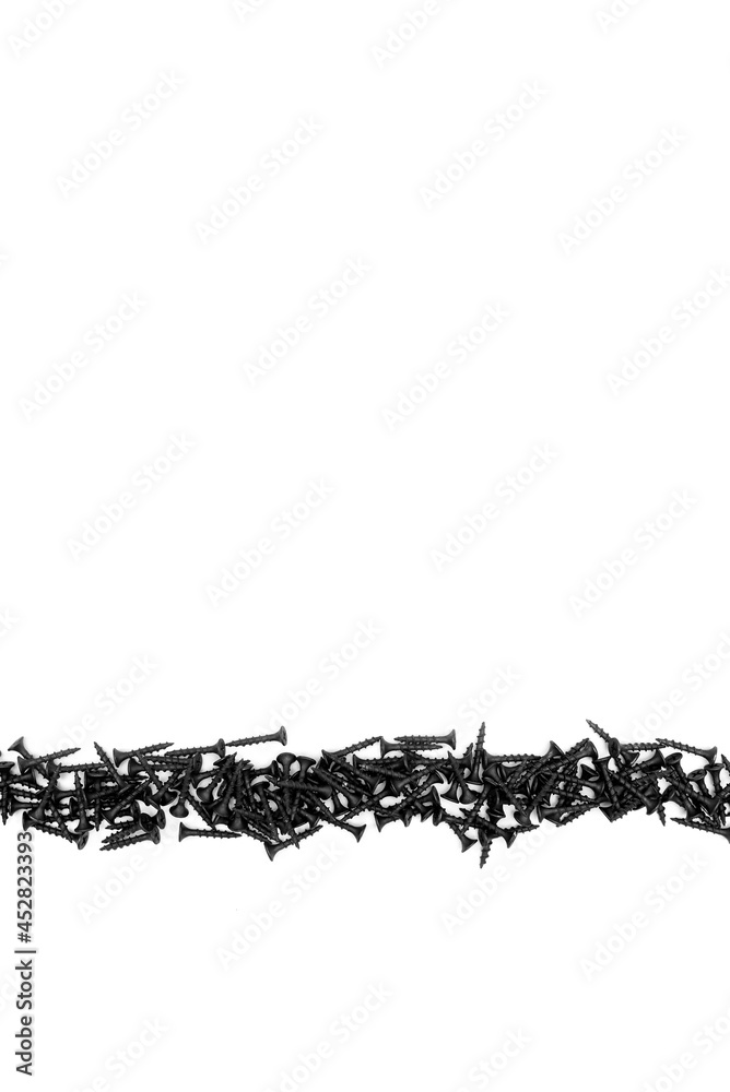 Black self-tapping screw on a white background. Close-up