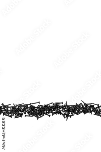 Fototapeta Naklejka Na Ścianę i Meble -  Black self-tapping screw on a white background. Close-up