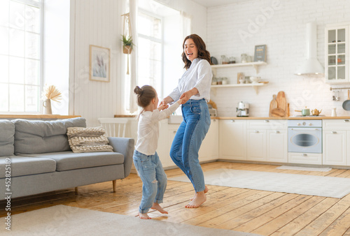 Mom and her daughter are dancing. photo