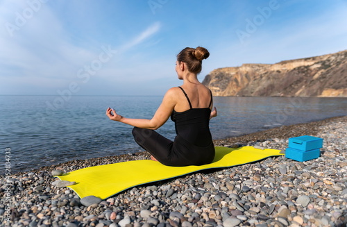 Young woman with long hair, fitness instructor in black Sportswe photo