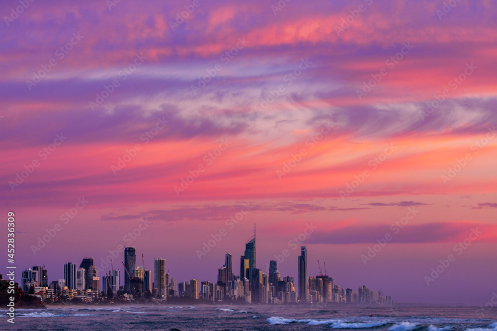 Colourful pink skies over Gold Coast cityscape.