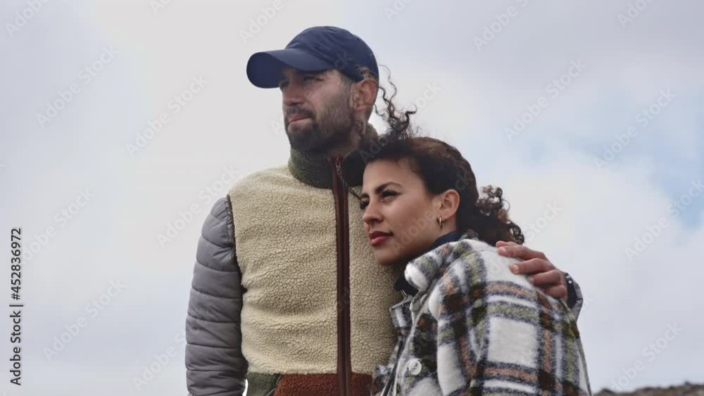Beautiful Couple Gazing Forward With the Background of the Bright Cloudy Sky Beautiful Couple Gazing Forward With the Background of the Bright Cloudy Sky