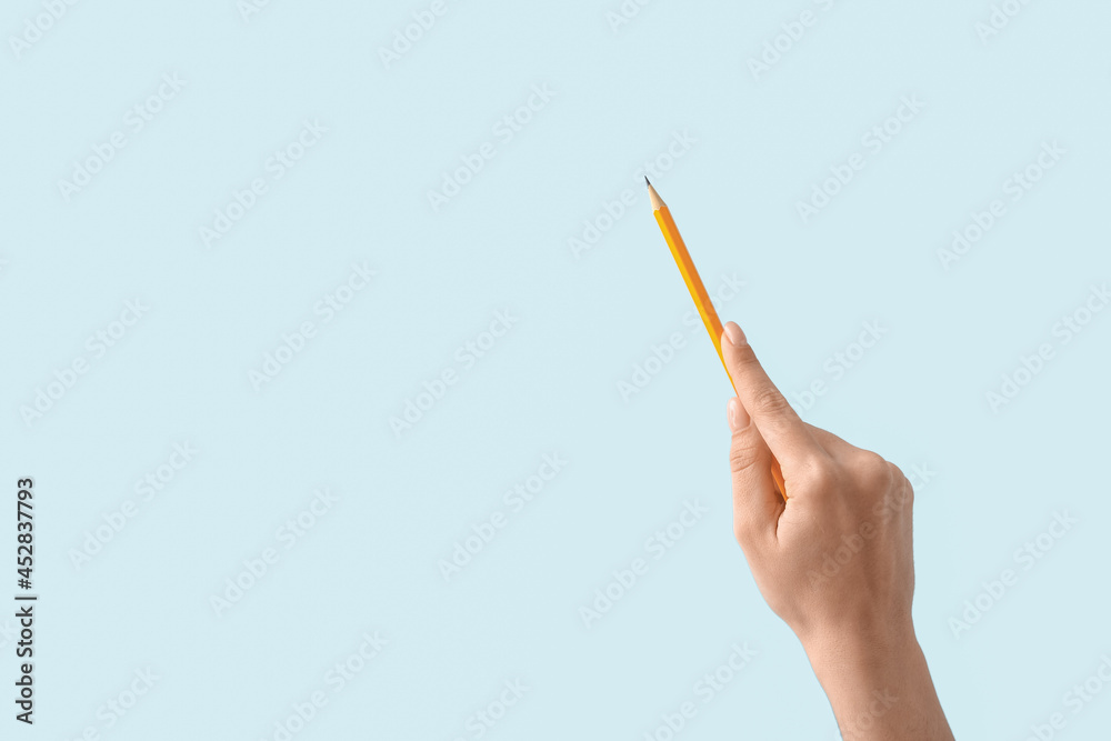Woman with pencil on color background Woman with pencil on color background