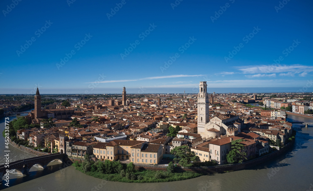 Aerial panorama of Verona, Italy. Panoramic top view of Verona city center. Italian churches in the old city aerial view. Historic Italian town panorama top view. Italian medieval city drone view.