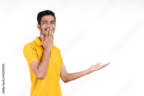 Young indian man showing expression with hand on white background