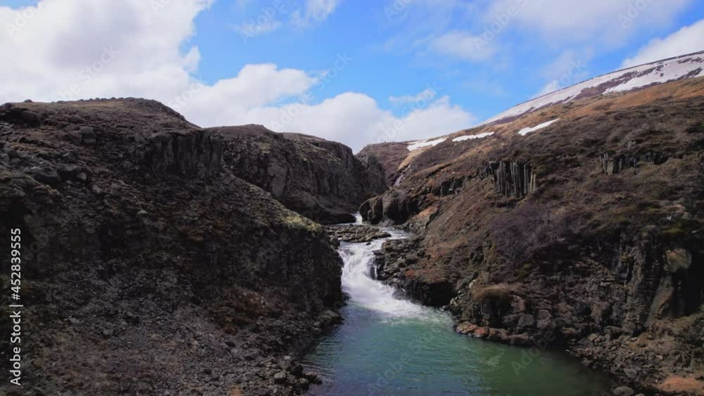 Aerial View of Side of a Canyon with a Small Body of Waterfall Aerial View of Side of a Canyon with a Small Body of Waterfall