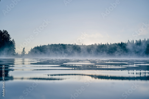 Fog rising over the water st sunrise