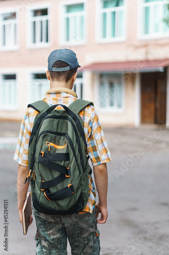 teen boy portrait on the way to school, education and back to school concept