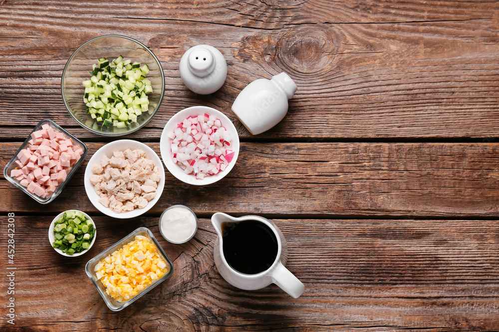 Different ingredients for okroshka on wooden background