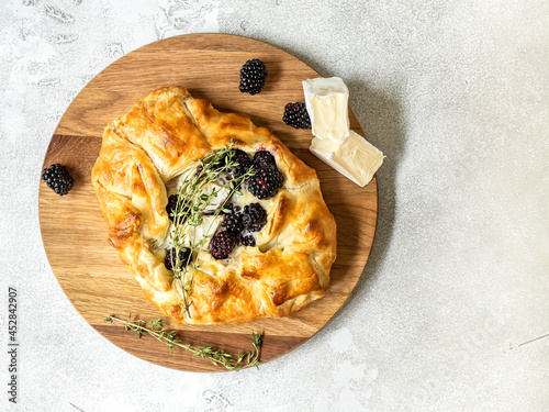 Baked brie cheese and blackberry open pie galette with thyme photo