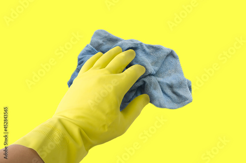 Old dirty torn rag isolated on yellow background. Cleaning rag