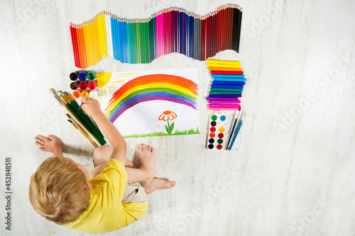 Child Painting Rainbow in Paper Album. Little Kid Drawing Colorful Picture. Children Development and Creative Arts Study Concept