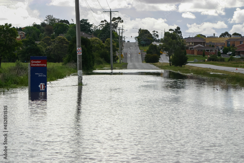 Deep flood water across Heatherton Road highway in Dandenong Stock