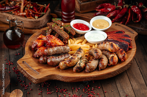 Wooden tray of beer appetizers set assortment with sauces