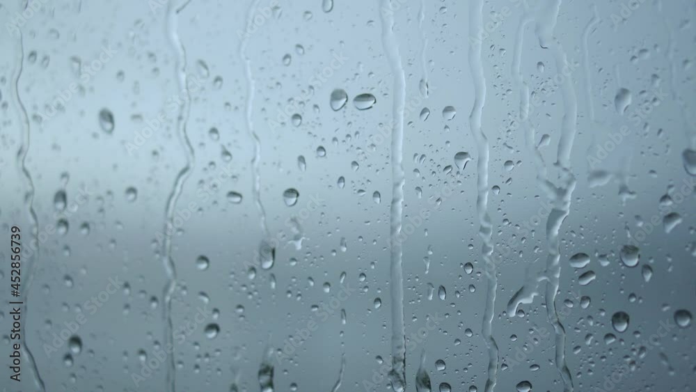 Raindrops roll down on the window. Bad depressive weather, heavy rain and wind Raindrops roll down on the window. Bad depressive weather, heavy rain and wind