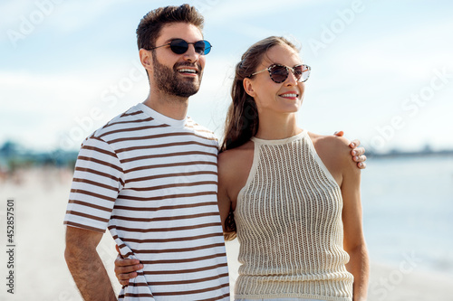 summer holidays and people concept - happy couple on beach