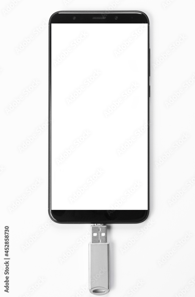 Portable USB flash drive connected to mobile phone isolated on white background. Mockup. High quality photo Portable USB flash drive connected to mobile phone isolated on white background. Mockup. High quality photo