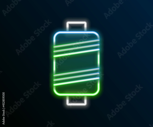 Glowing neon line Sewing thread on spool icon isolated on black background. Yarn spool. Thread bobbin. Colorful outline concept. Vector