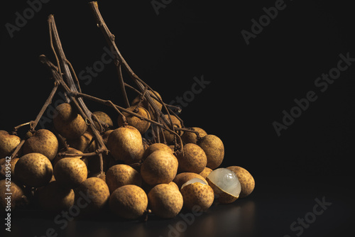 Close-up longan (Dimocarpus longan) isolated on black backdrop used for fruit background.