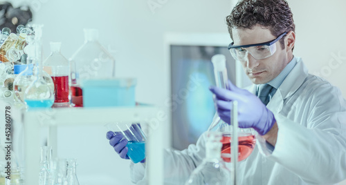 Researcher performing scientific experiment in chemical laboratory.