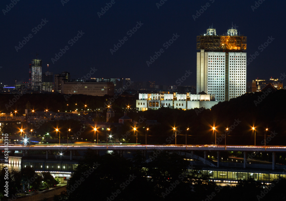 Moscow,Russia, Jul 20,2021: Luzhniki Metro Bridge over Moscow river in night.  Building of Russian Academy of Sciences