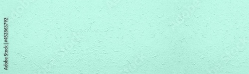 Rough crumpled surface large texture. Pastel mint green textured surface abstract wide background