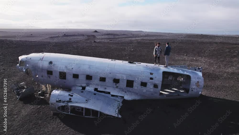 Aerial Breathtaking View of a Couple on Top of the Solheimasandur Plane Wreck Aerial Breathtaking View of a Couple on Top of the Solheimasandur Plane Wreck