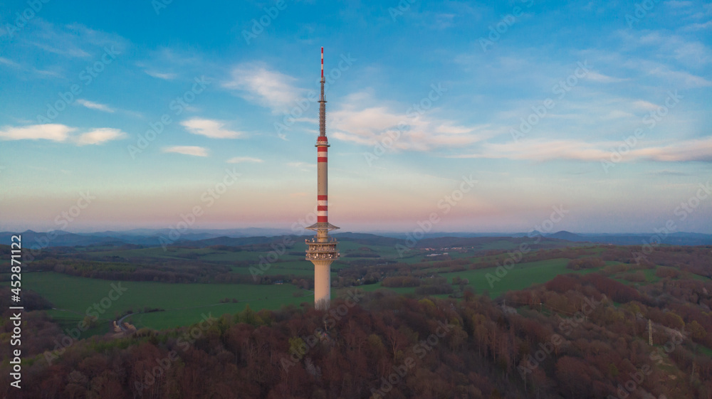 Communications TV tower on Bukova hora is the tallest free-standing transmission tower in Czech Republic.Aerial view of Czech landscape at sunset.