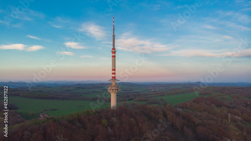 Obraz na płótnie Communications TV tower on Bukova hora is the tallest free-standing transmission tower in Czech Republic.Aerial view of Czech landscape at sunset. w salonie