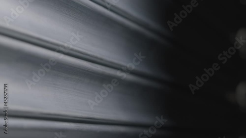 Close Up Shot of a Metal Roller Shutter Opening Part 2 of 2